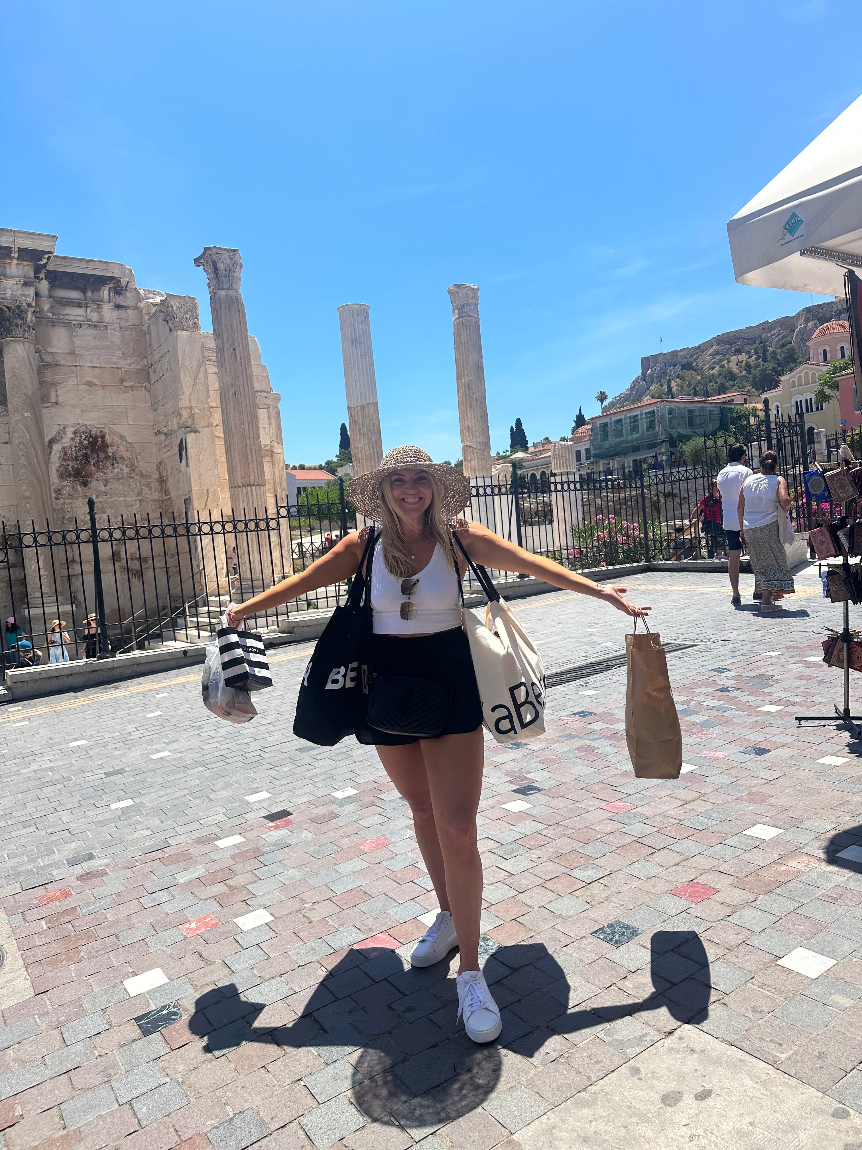 Posing for a photo holding shopping bags