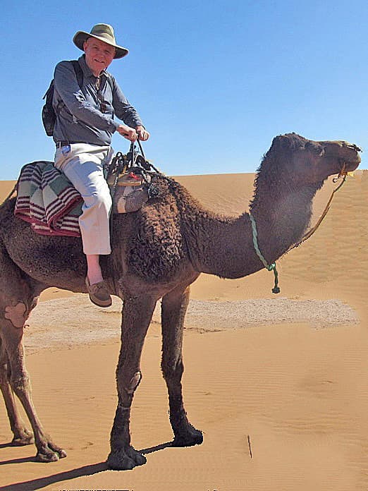 Couple riding on camels in a desert