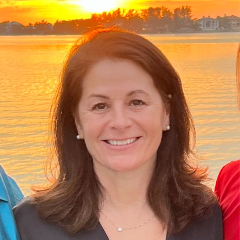 Travel Advisor Jane Maltby in a brown shirt with the sunset in the background.