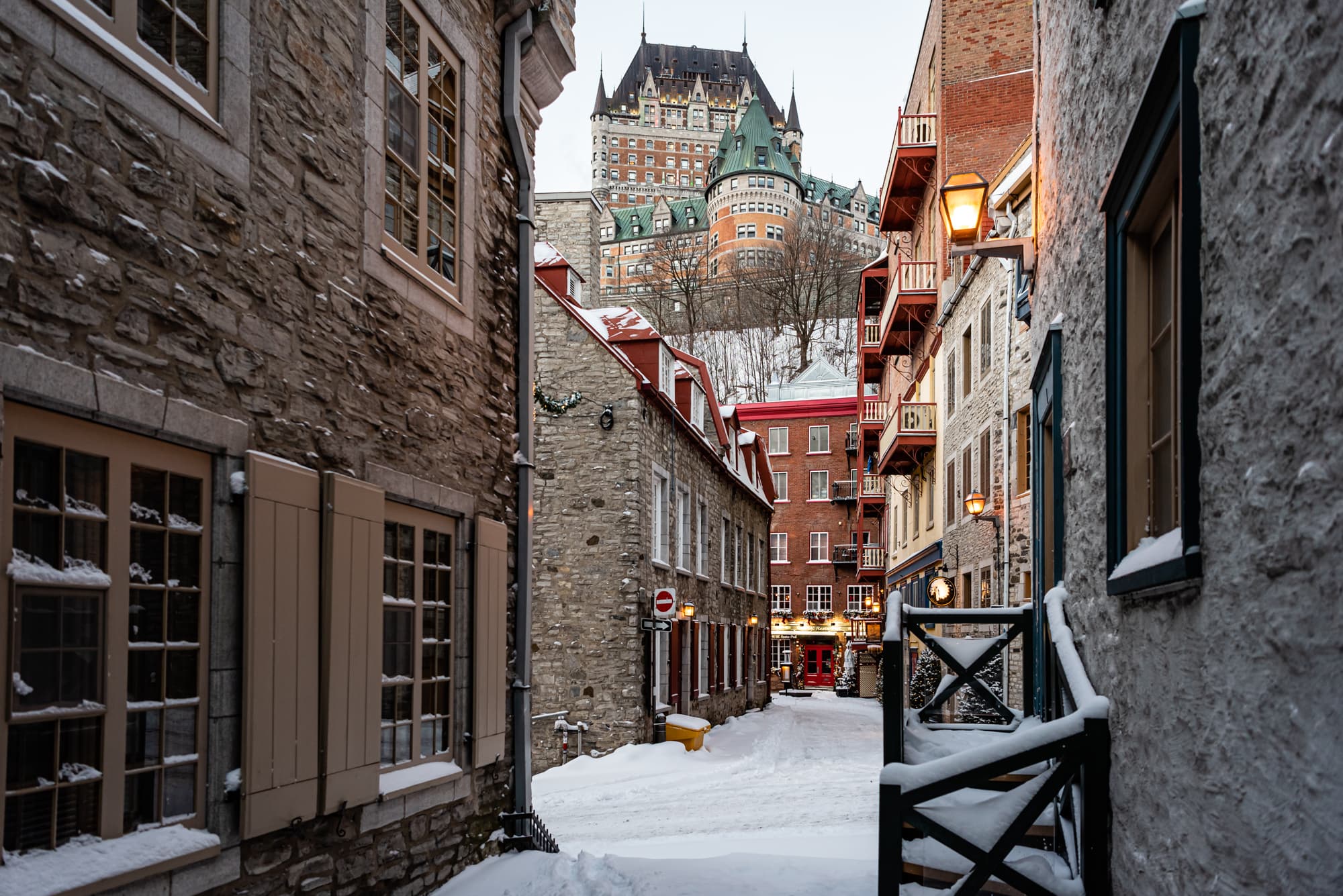 A snow covered street with buildings.