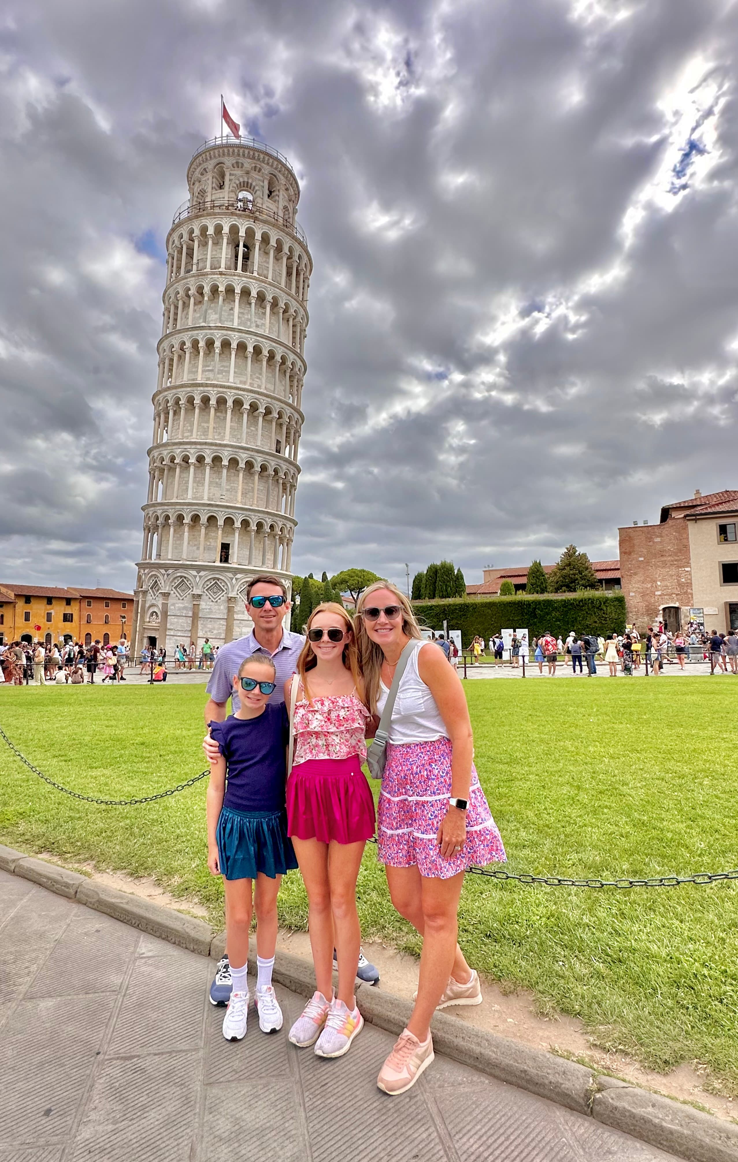 Posing for a family photo at The Leaning Tower of Pisa