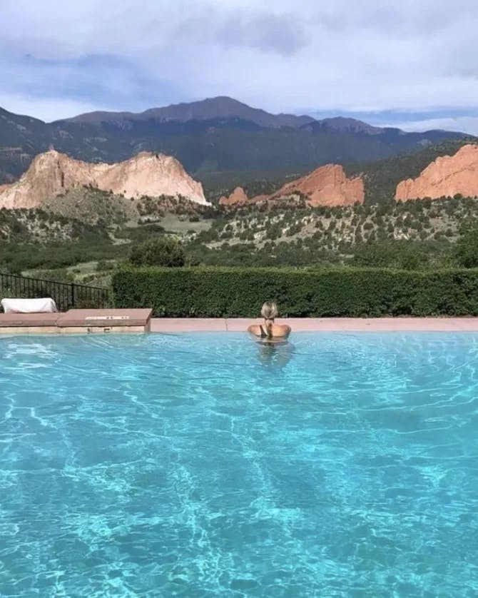 Picture of Sarit in pool at Garden of the Gods Resort & Club with beautiful, natural views in the distance. 