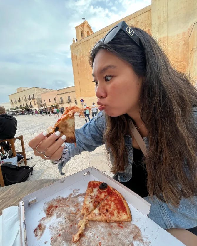 Picture of Katherine eating pizza