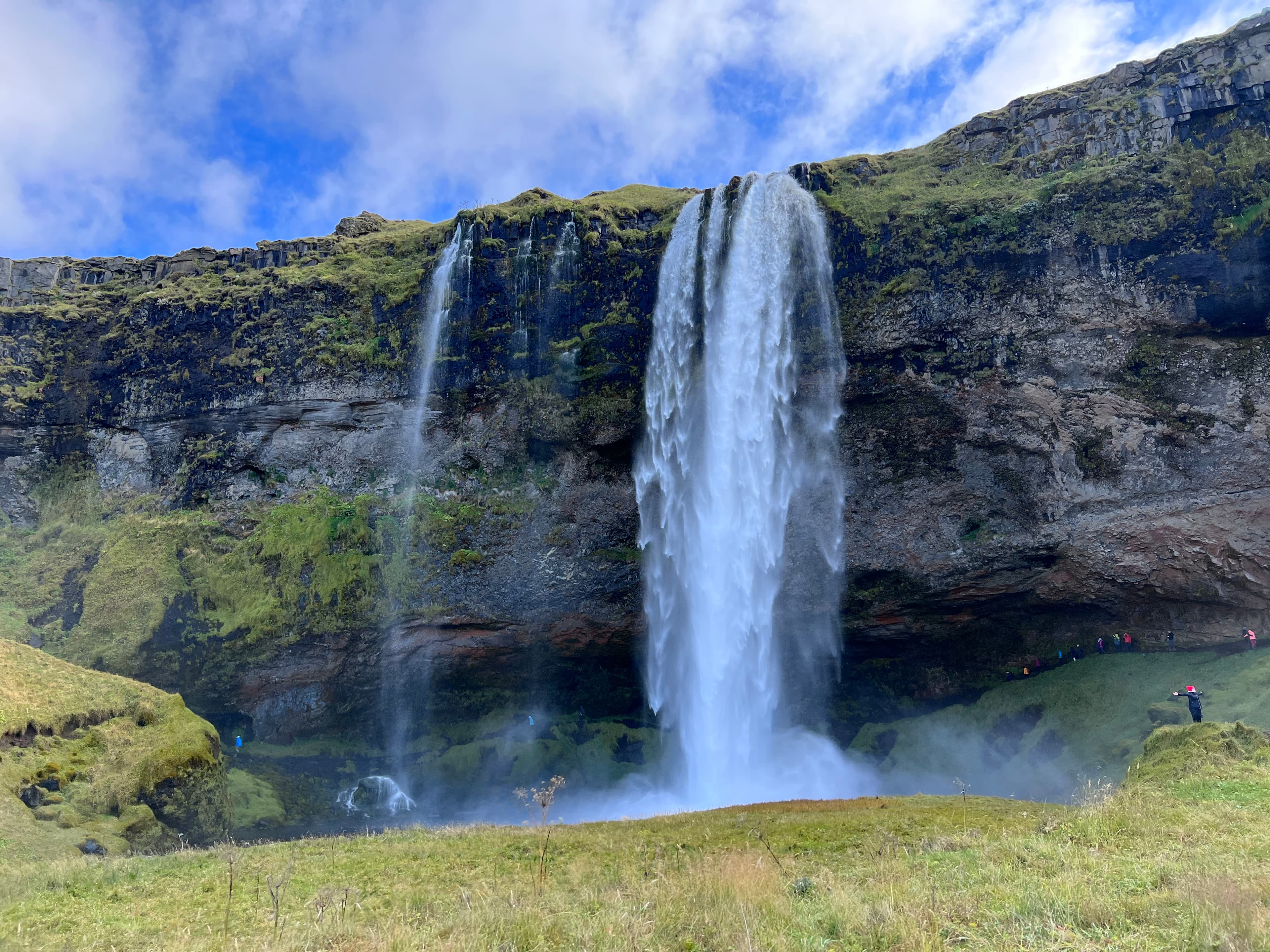 Travel advisor taking picture of a beautiful water fall