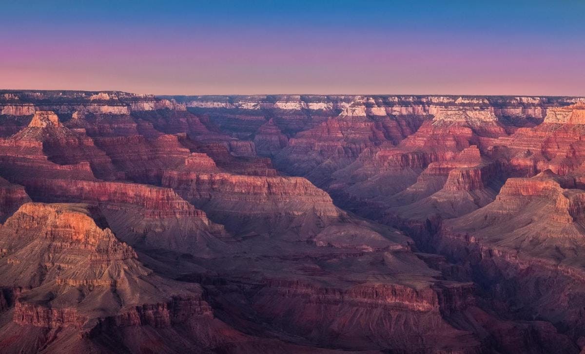 Grand Canyon during purple and red sunset. 