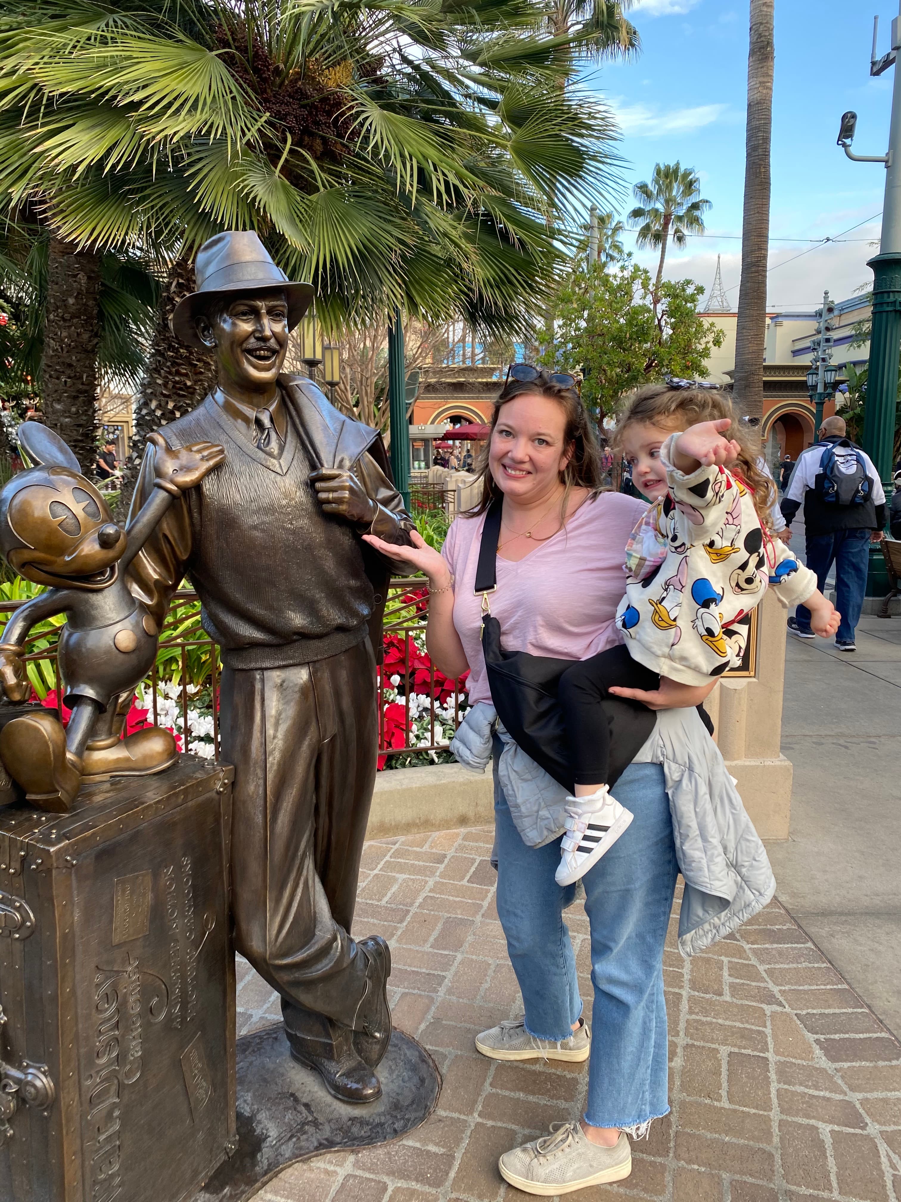Posing with a statue at Disney