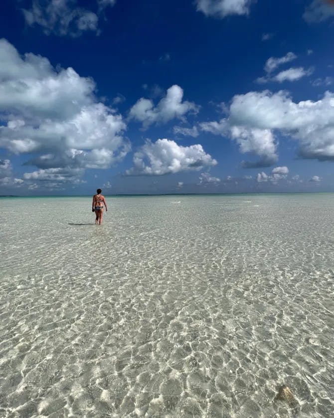 Picture of Emmy on an endless beach with gorgeous clouds 