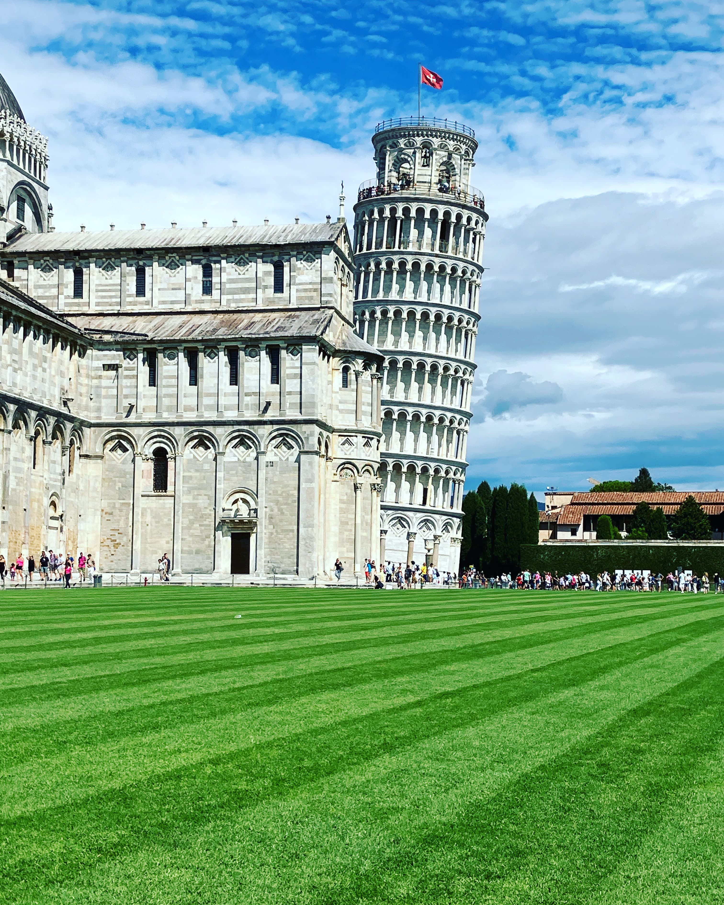 Tower of Pisa with green grounds outside