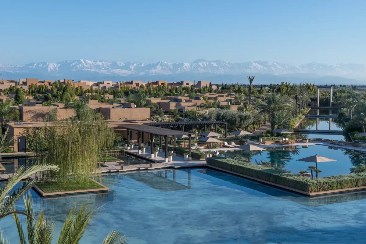 Calm water features rise up to wooden piers, gardens and outdoor lounge areas at Marrakech's Mandarin Oriental resort