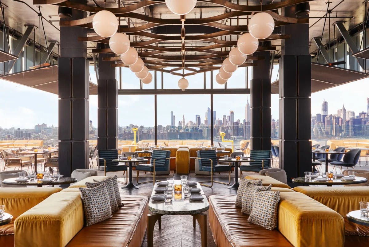 a stylish rooftop restaurant overlooking a city skyline