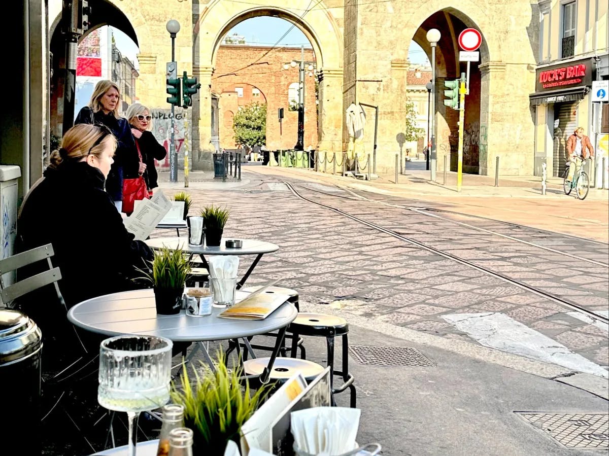 Outdoor sitting of a restaurant on a street.