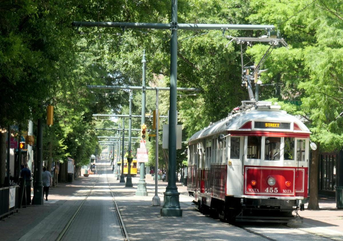 Cable car in Memphis through tree-lined streets.