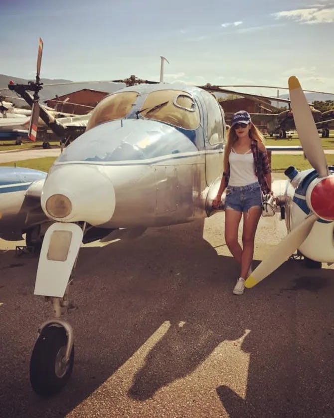 Girl posing with a jet.