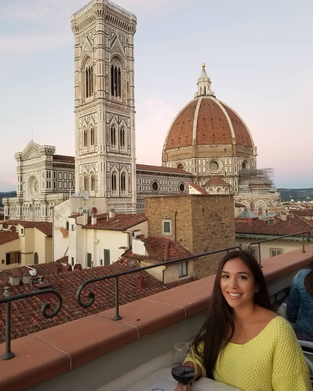 A woman sitting in a yellow top.