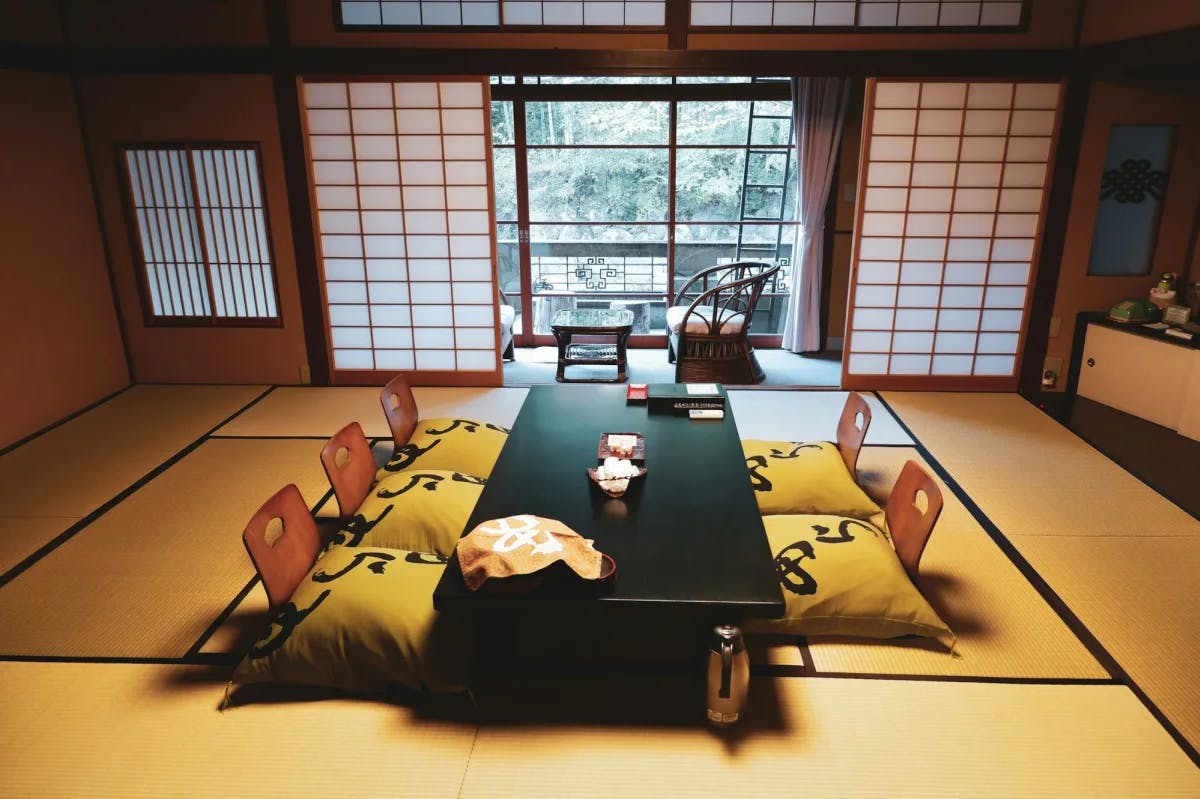 Traditional tatami matting and pillow seating lines the floors of a Ryokan in Japan
