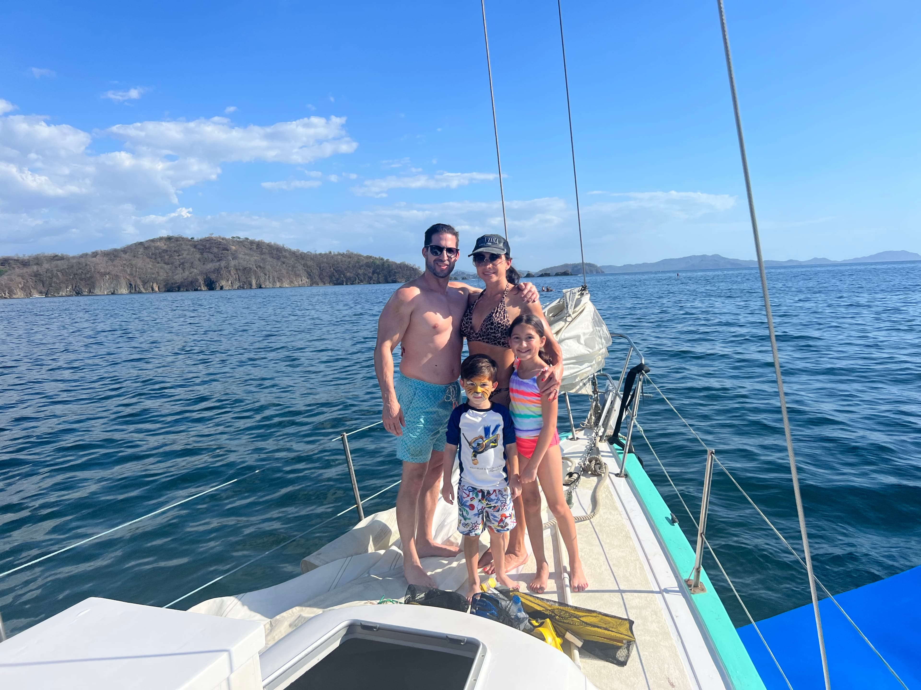 Family picture on the edge of a yacht