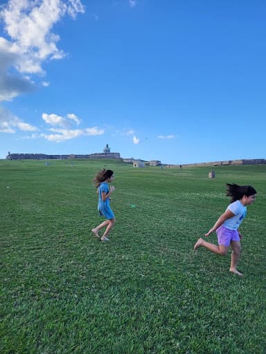 Kids running on hill.
