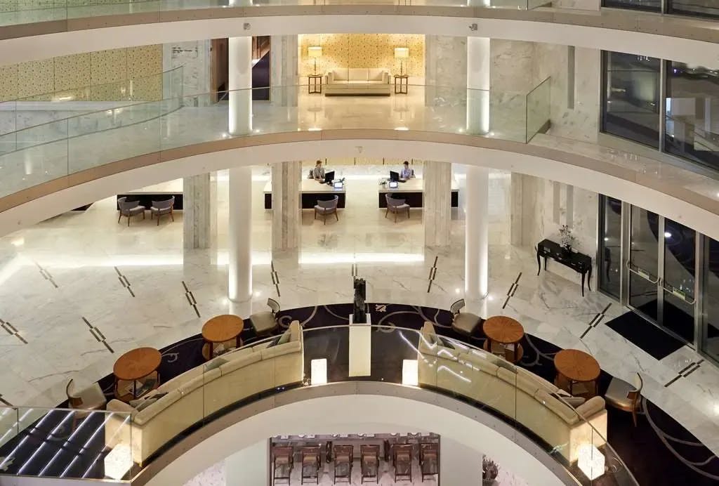 Opulent columns, glass windows and marble floors mark the rotunda-shaped lobby of Conrad Algarve