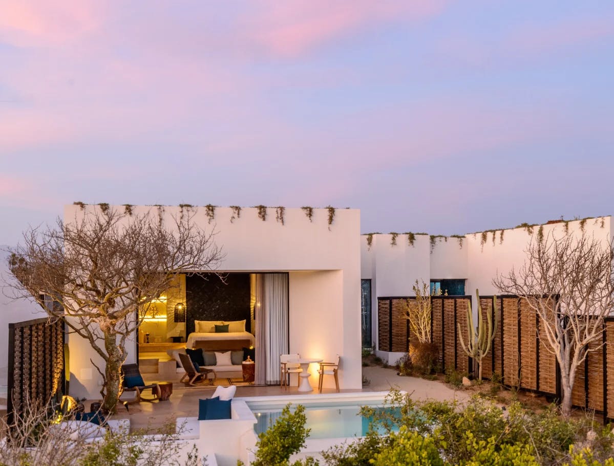 white casita with a private plunge pool against a blue and pink sunset sky