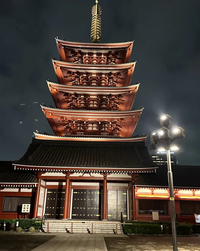 A photo of a red temple lit up at nighttime
