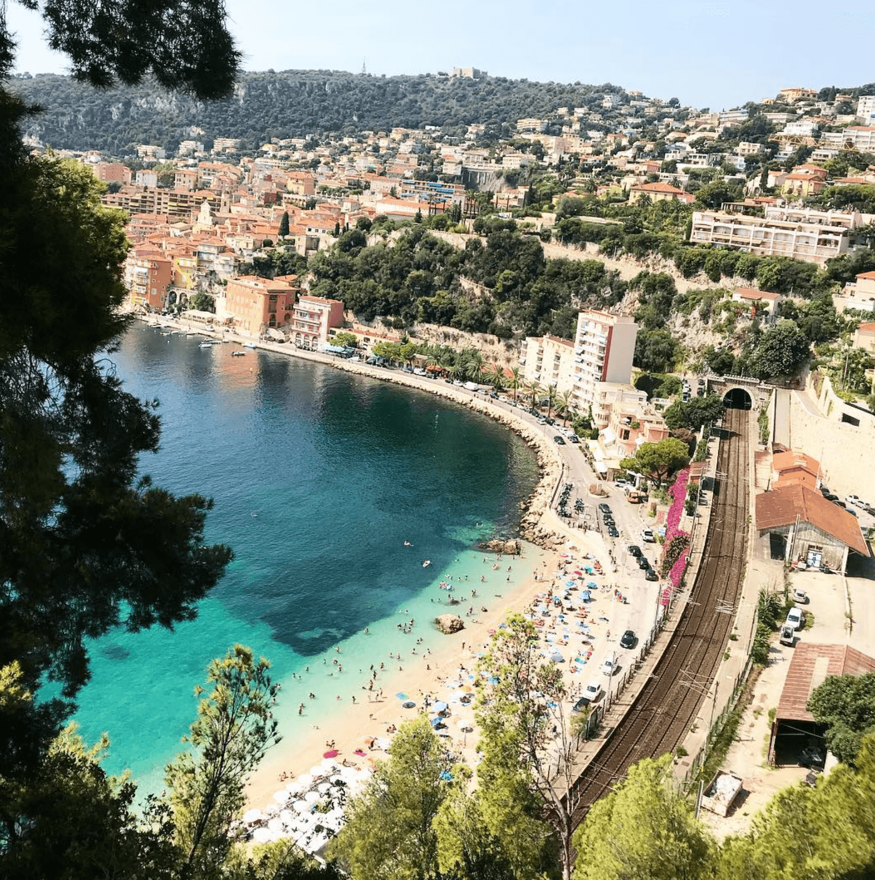 View of a coastal town with a clear blue coast line.