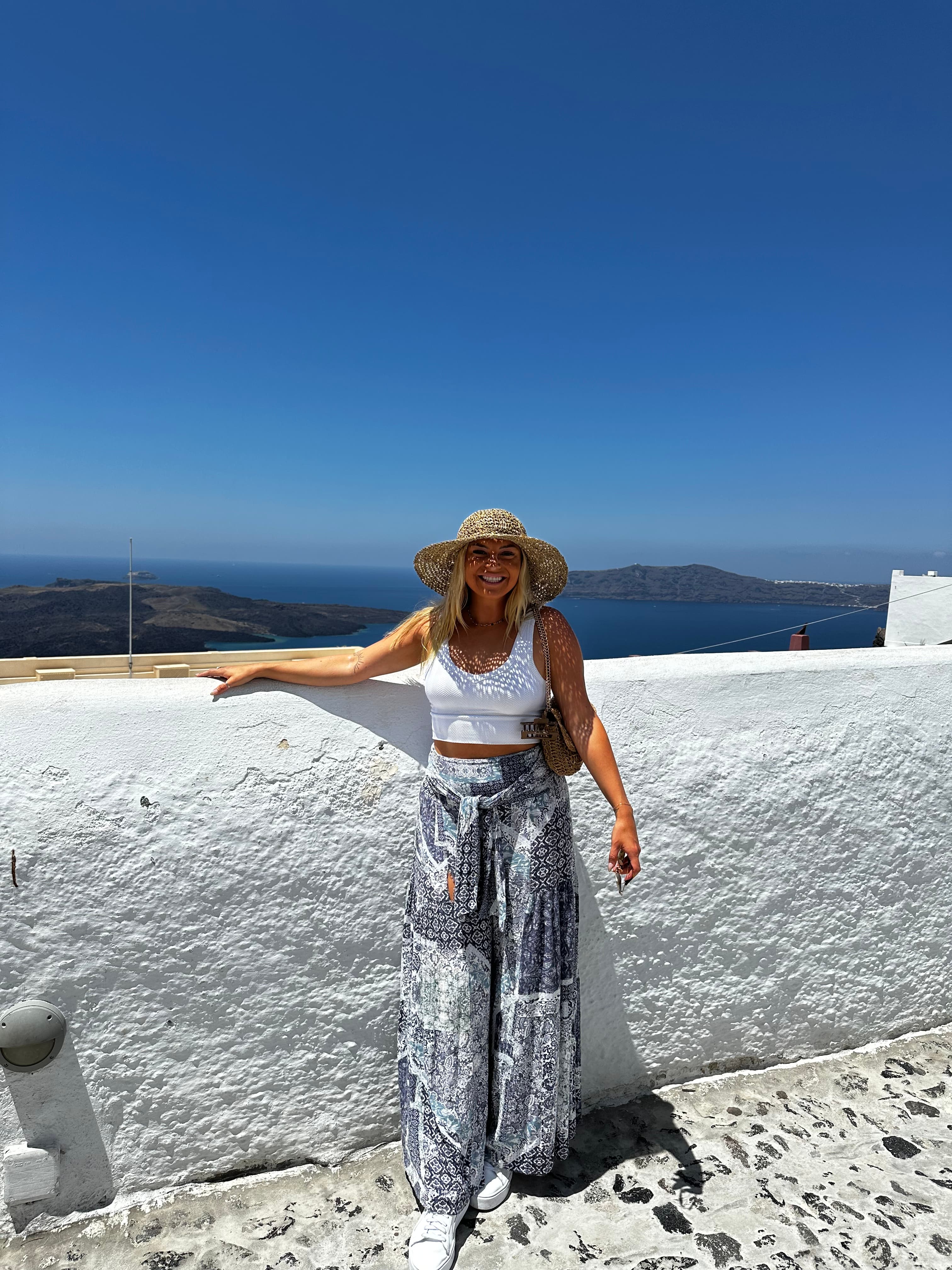 Posing for a photo dressed in a white outfit