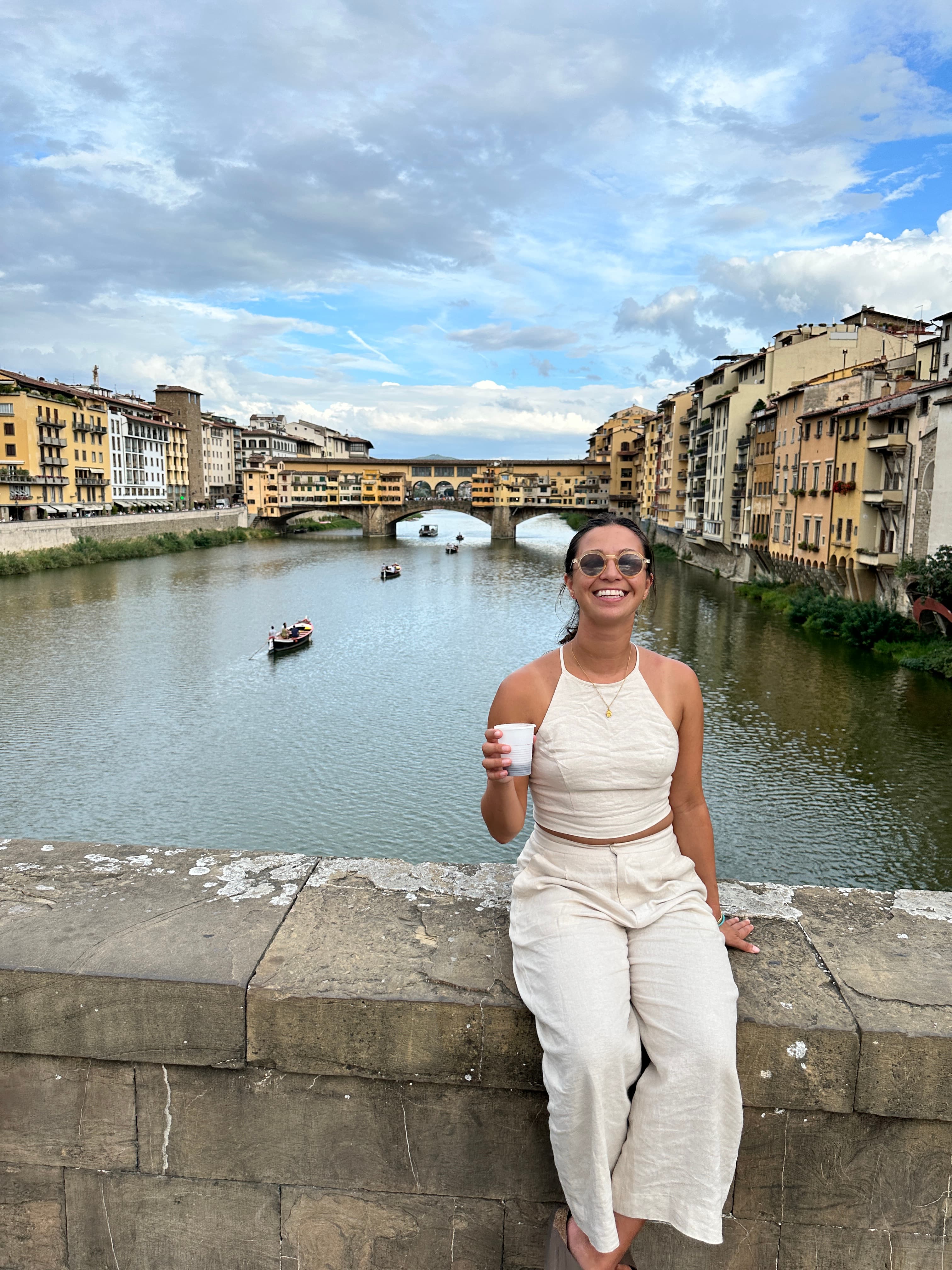 Janet standing and posing on a bridge with canal in the background