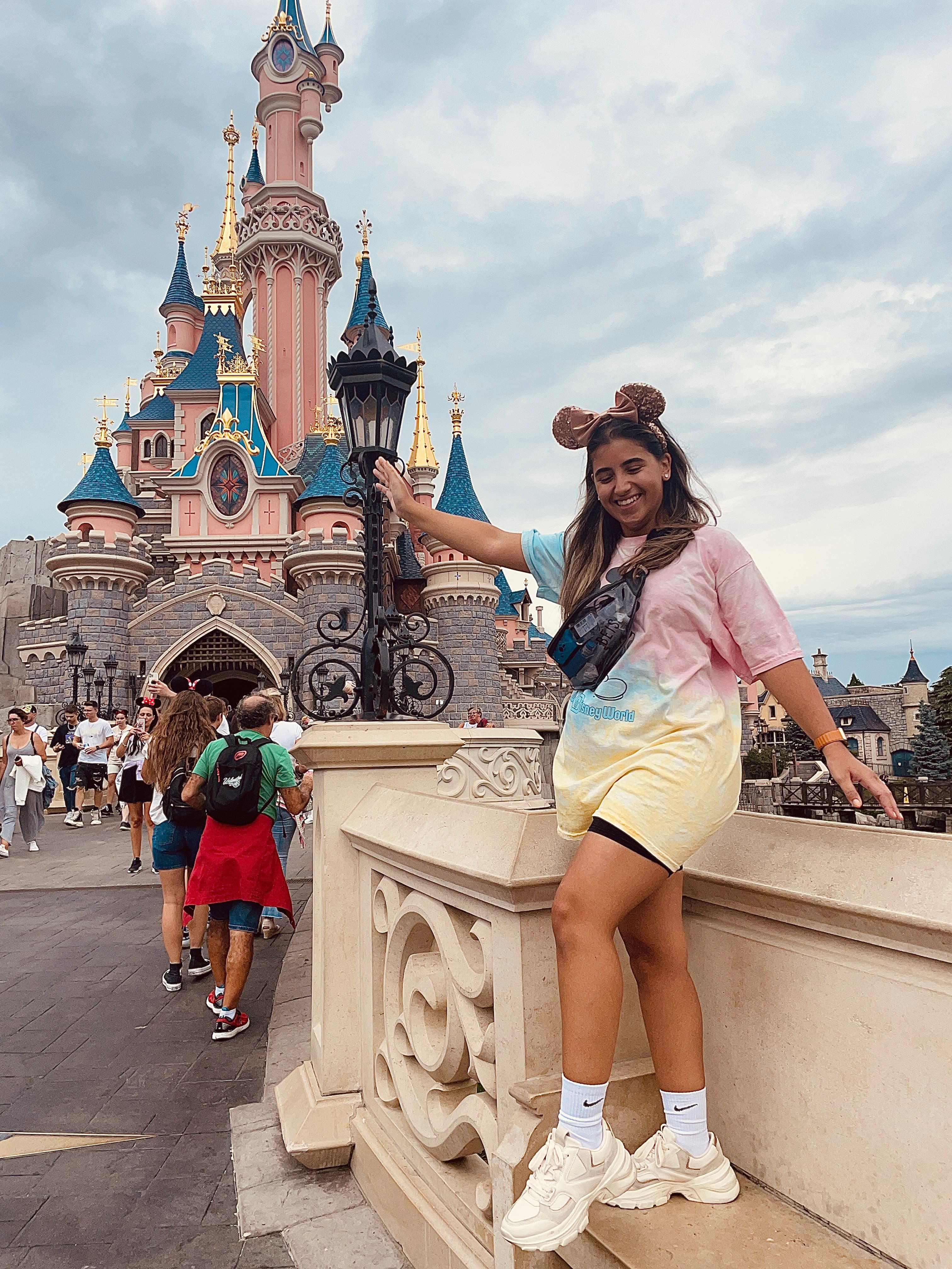 Travel advisor posing in front of Disney land