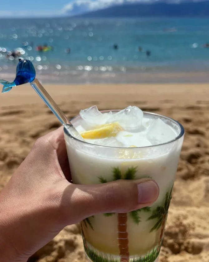 Picture of a juice glass on a beach