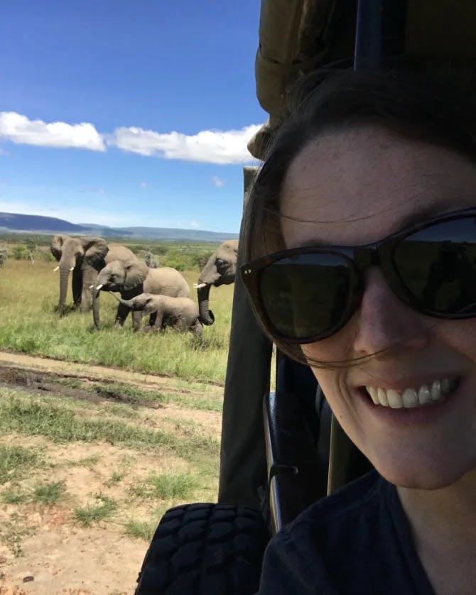 Picture of Leanne wearing sunglasses with elephants in the wild