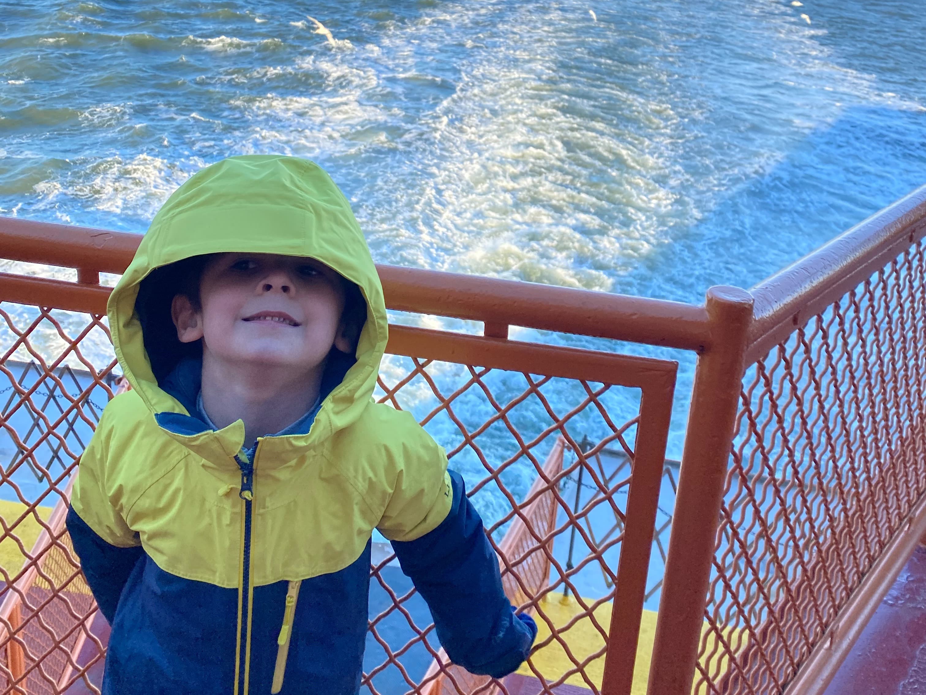 kid enjoying and wearing yellow hoodie