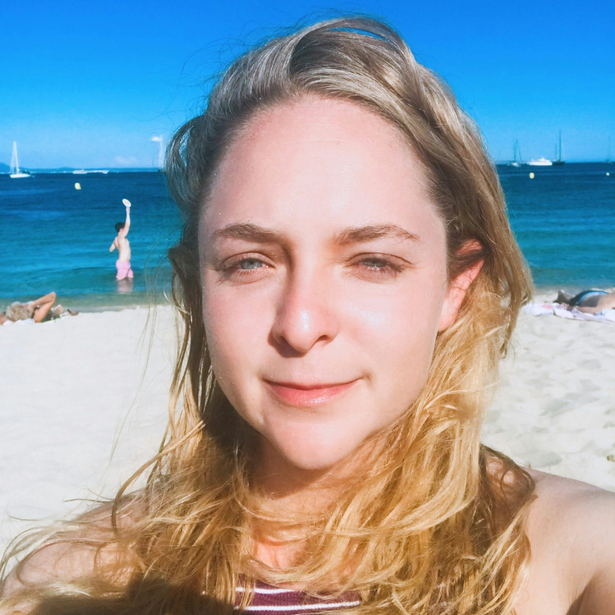 Travel Advisor Sarah Shafer smiling on a beach.