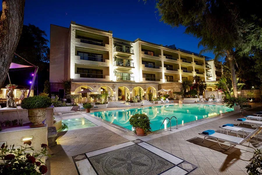 Elaborately decorated with classical designs, the pool area and courtyard of Rodos Park wows at night