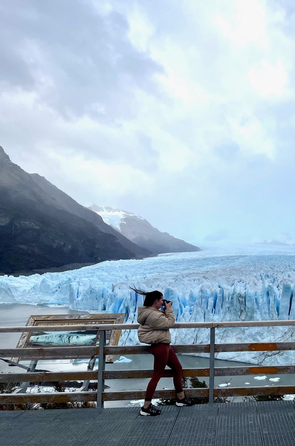 Advisor next to a frozen waterfall.