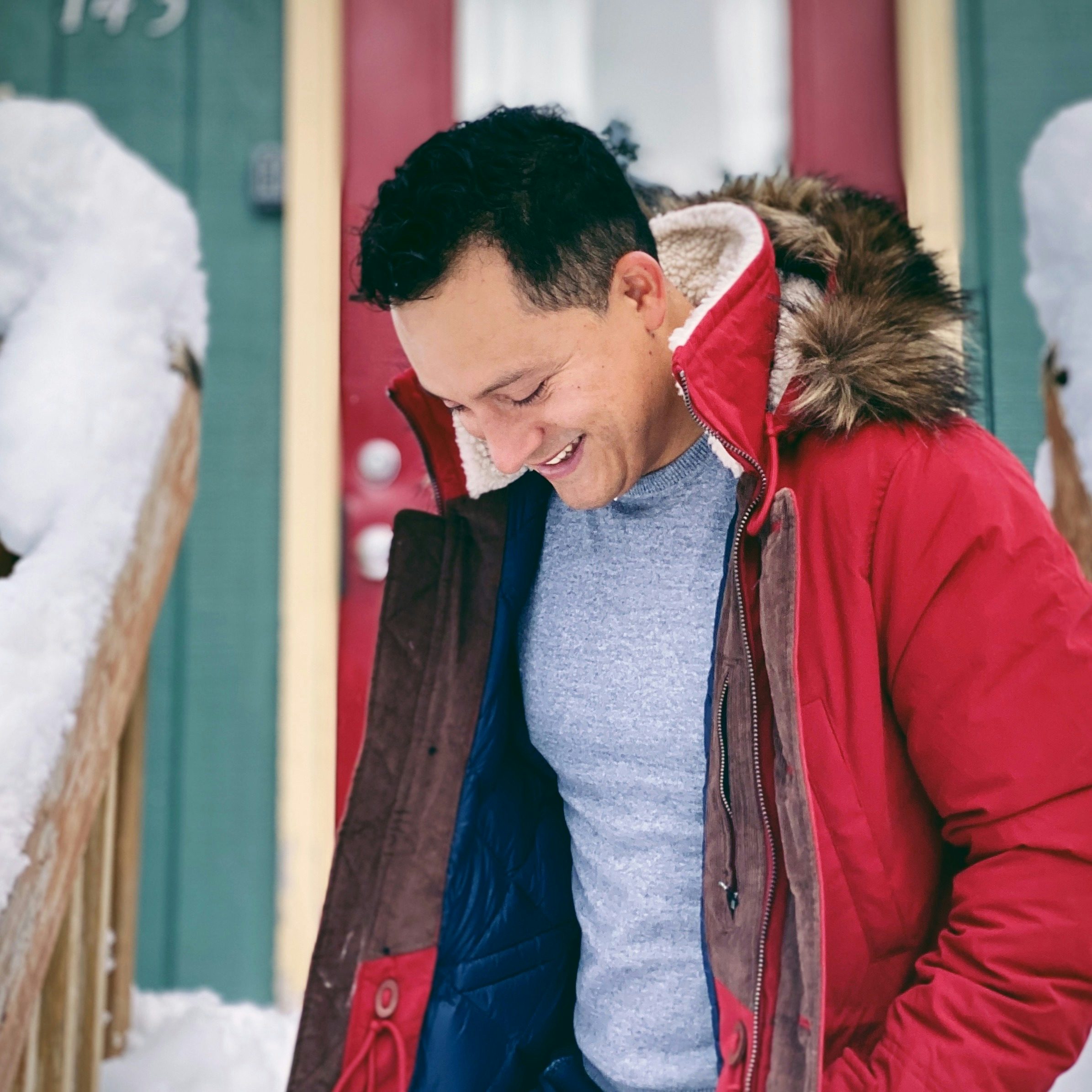 Travel Advisor Edwin Trejo in a red jacket outside in the snow.