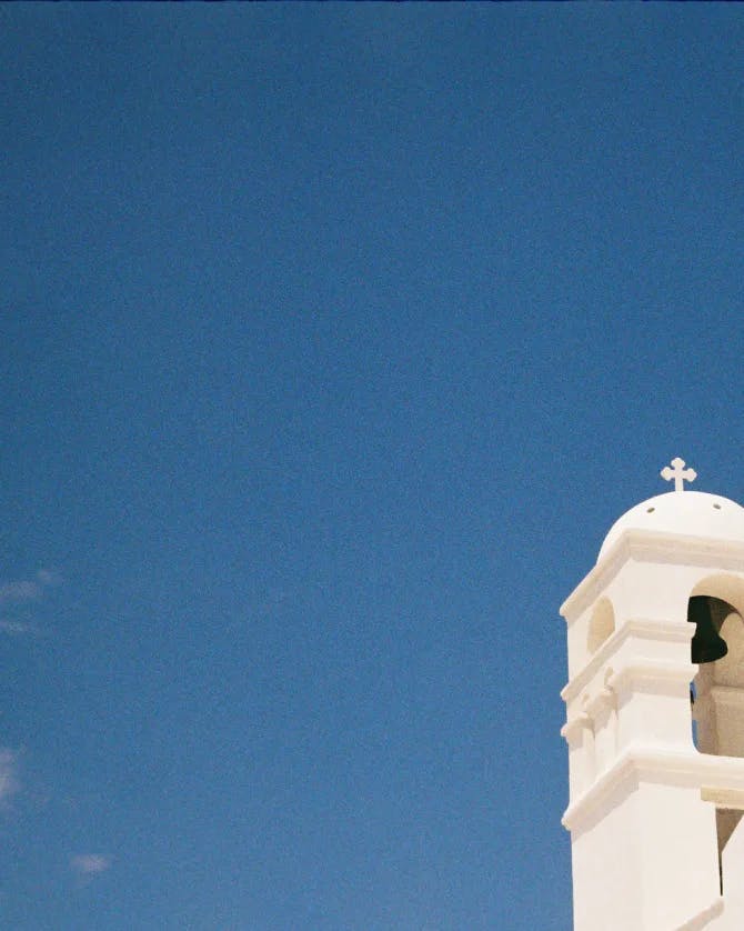 White church building with blue sky. 