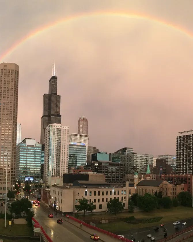 Picture of a double rainbow over a city skyline