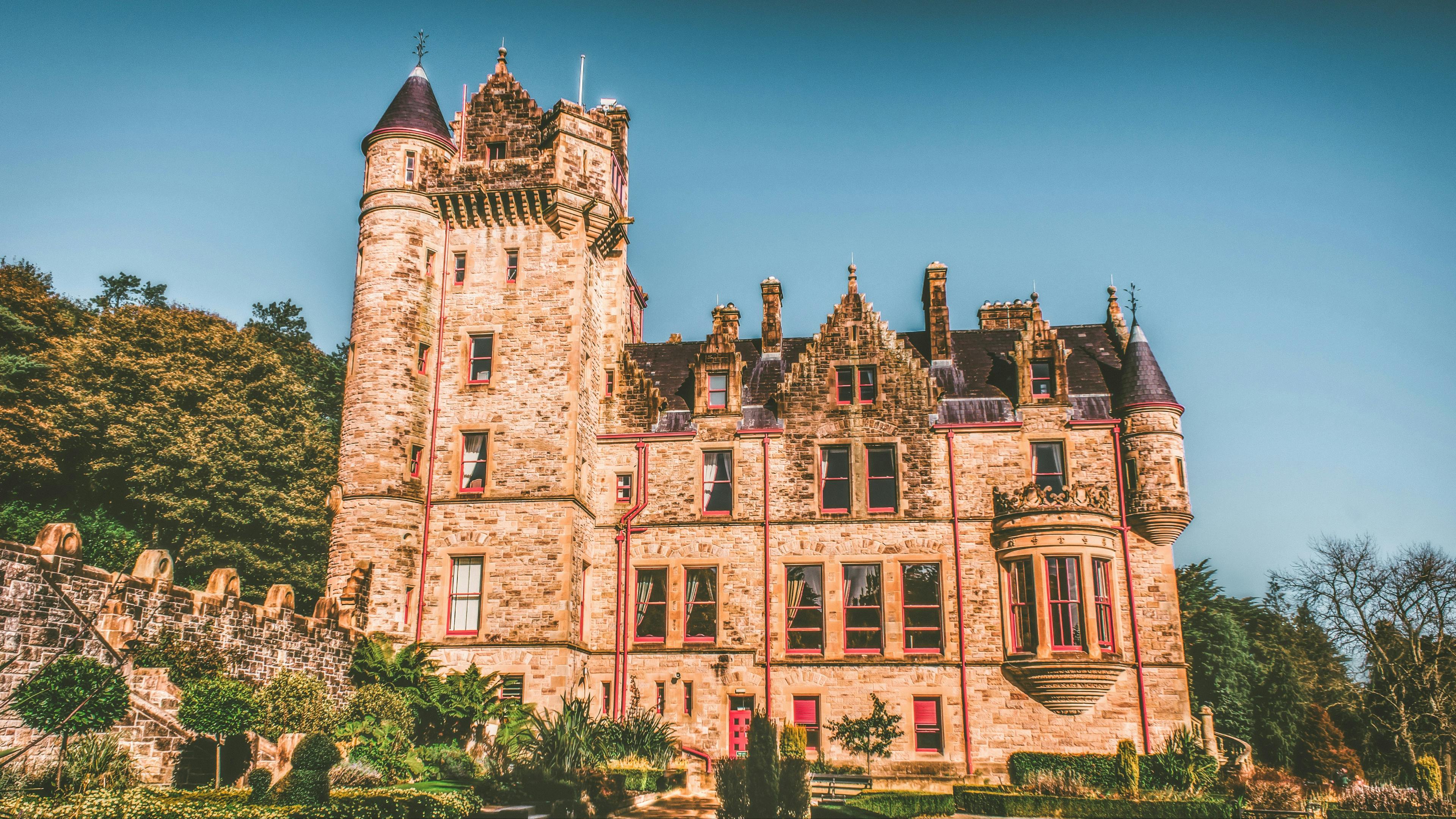 A pink-hued Belfast Castle on a sunny day.