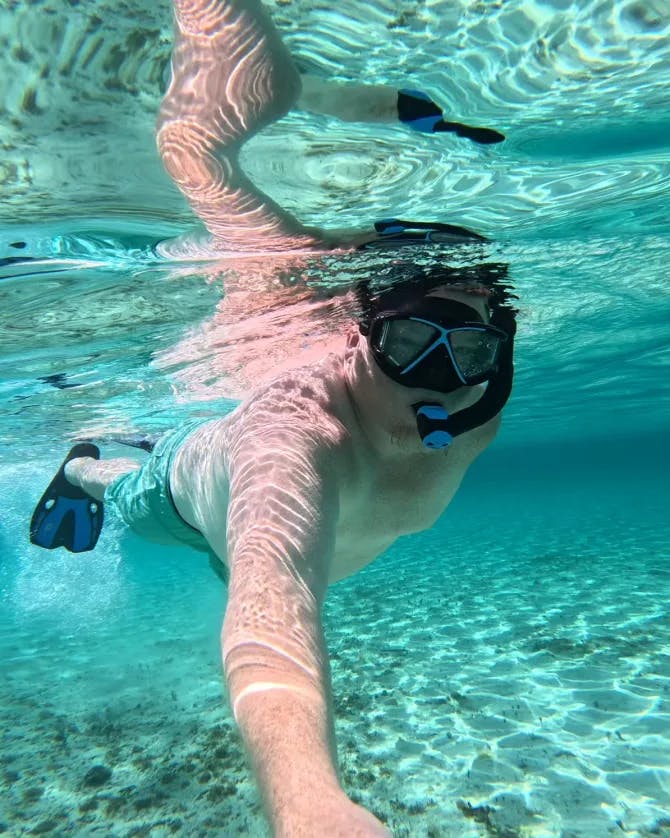Picture of Jacob swimming with scuba goggles on underwater