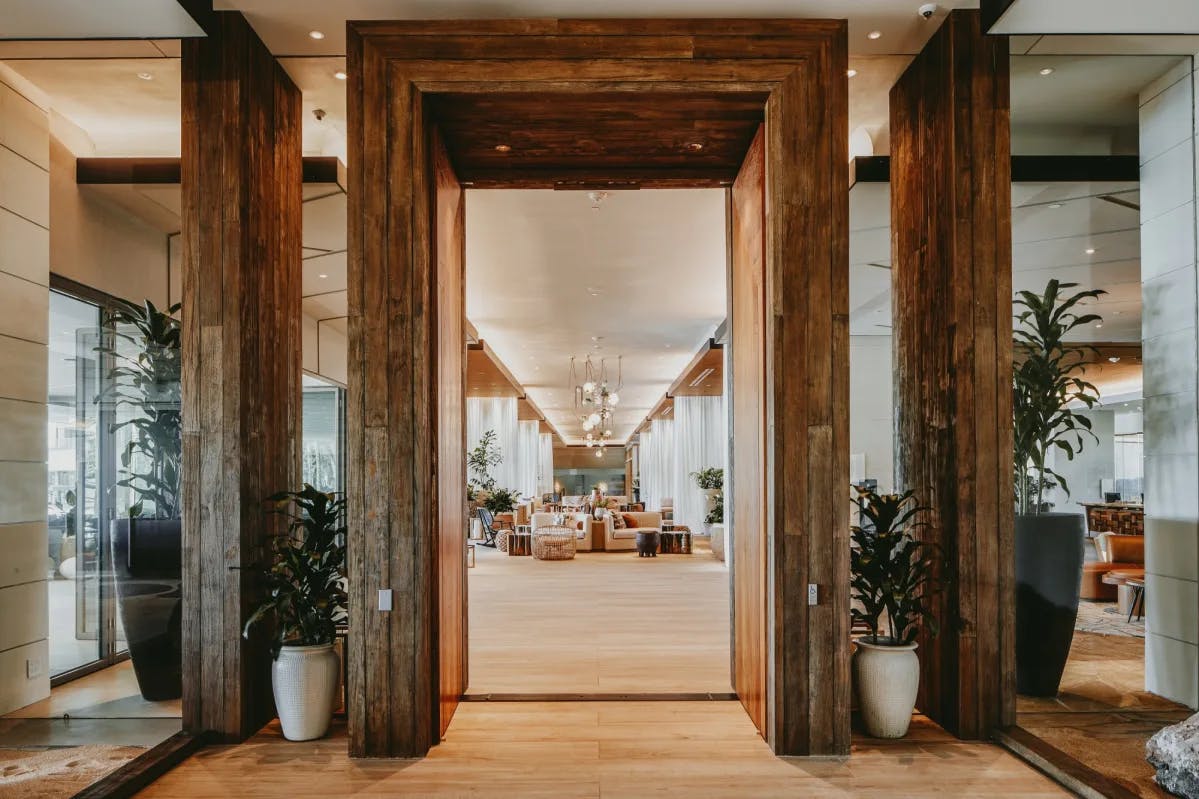 stylish wooden entrance looking into a light-filled lobby