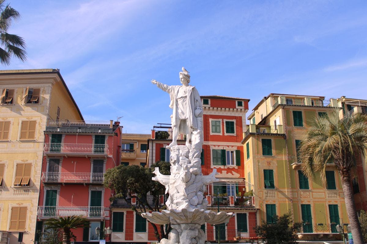a picture of a statue in front of some buildings 