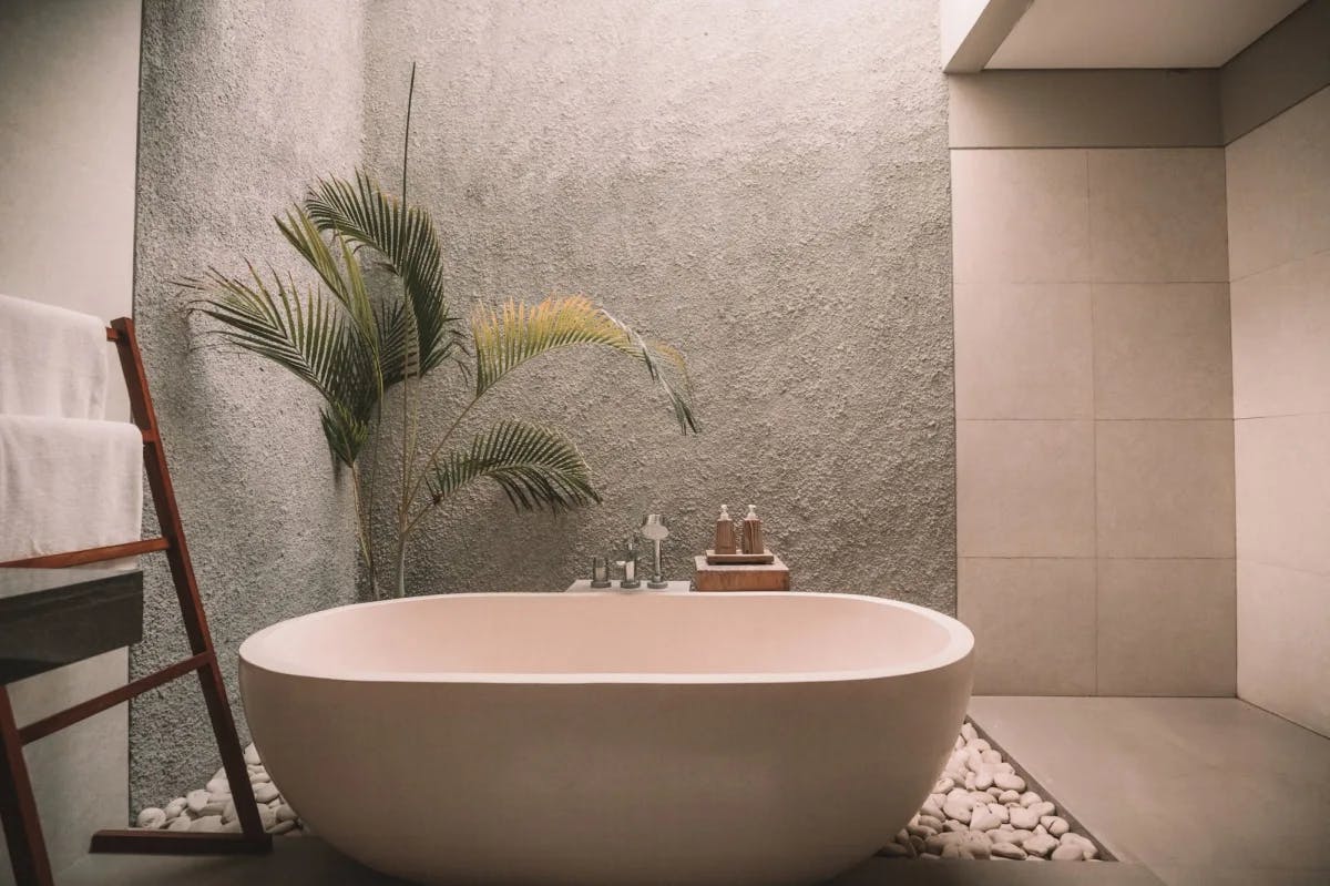 A luxury spa tub with natural tones and a minimalist, naturalist aesthetic 
