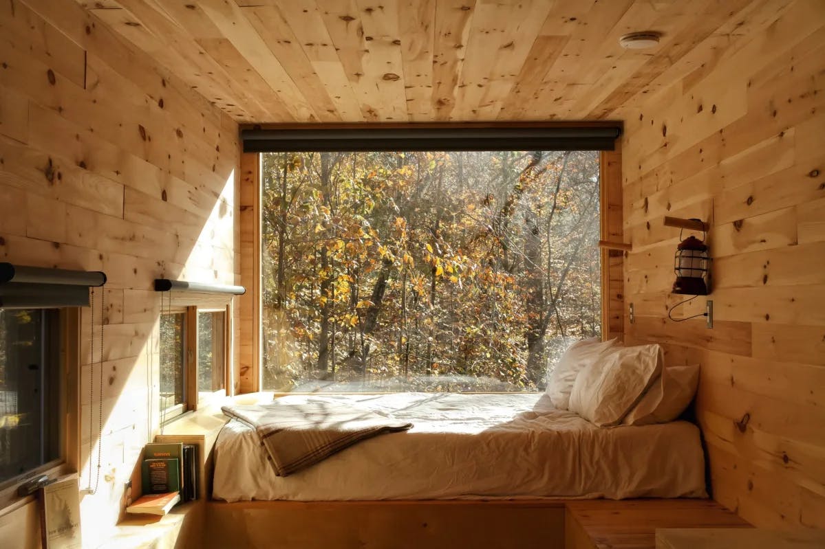 cozy bed in a small wooden cabin