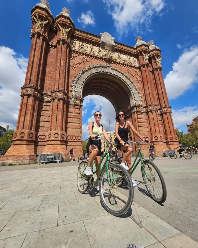 Alexandria and a friend on a bicycle at Arco de Triunfo de Barcelona