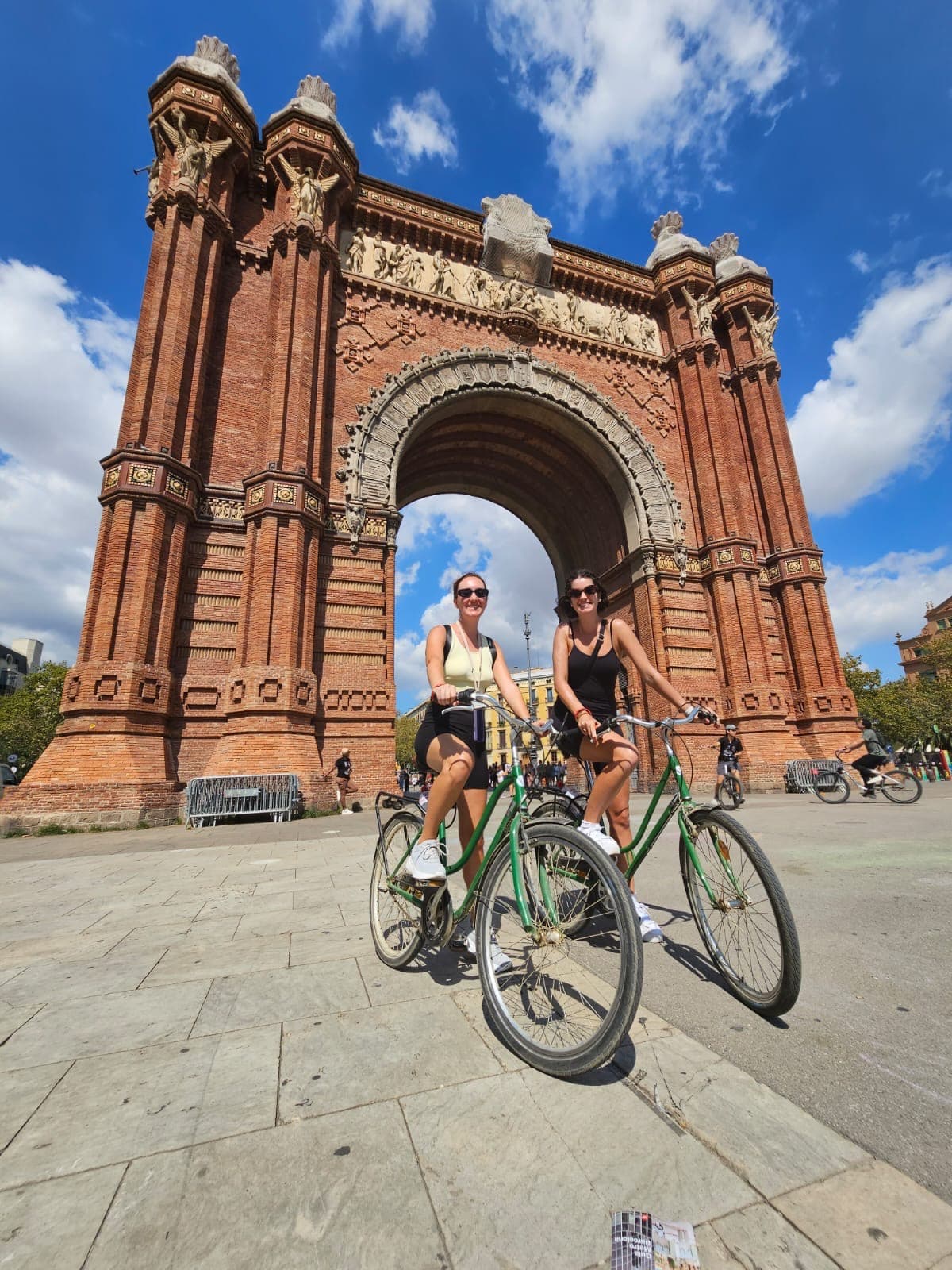 Alexandria and a friend on a bicycle at Arco de Triunfo de Barcelona
