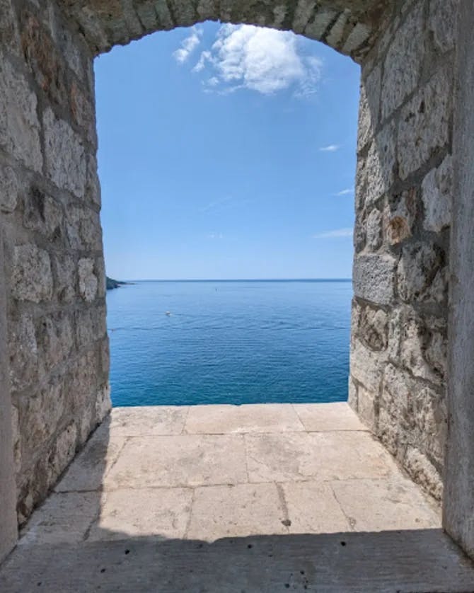 View of sea through stone peep hole.