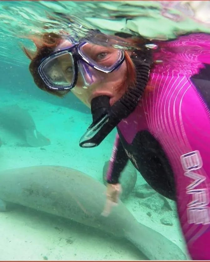 Robyn wearing scuba gear with animals underwater