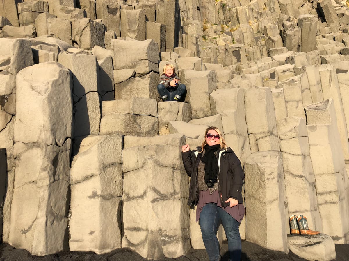 Karilyn with her young son perched up on a rock.