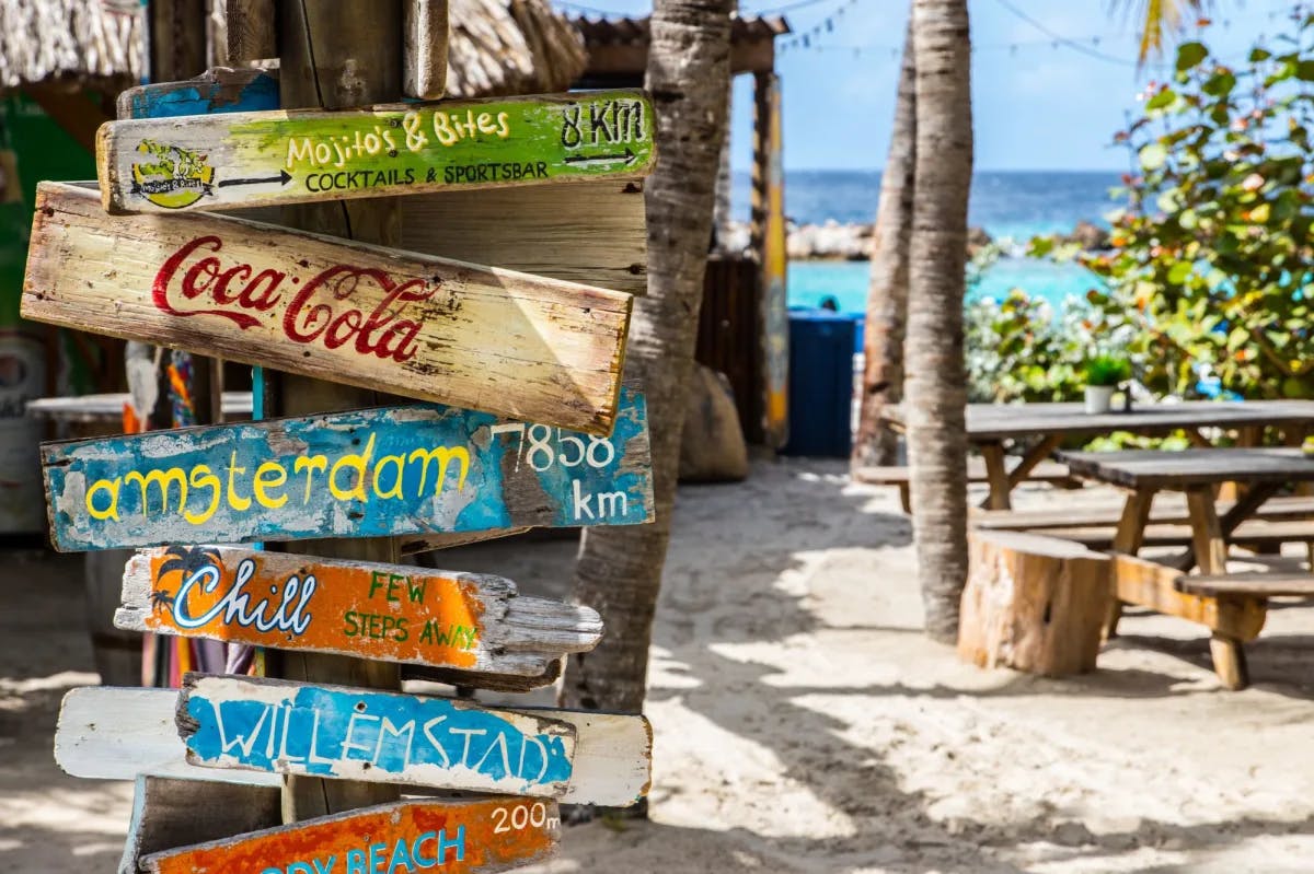 Coca cola wooden sign board near beach. 