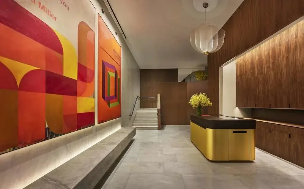 a sexy lobby area with marble floors and bright modern art
